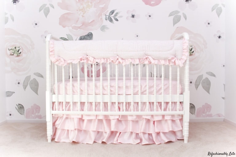 stunning floral wallpaper wall with a white Jenny Lind style bed and pink bedding