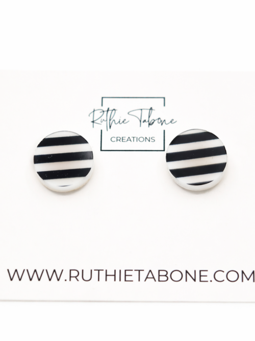 Black and white striped round stud earrings displayed on a Ruthie Tabone Creations card, photographed on a clean white background.