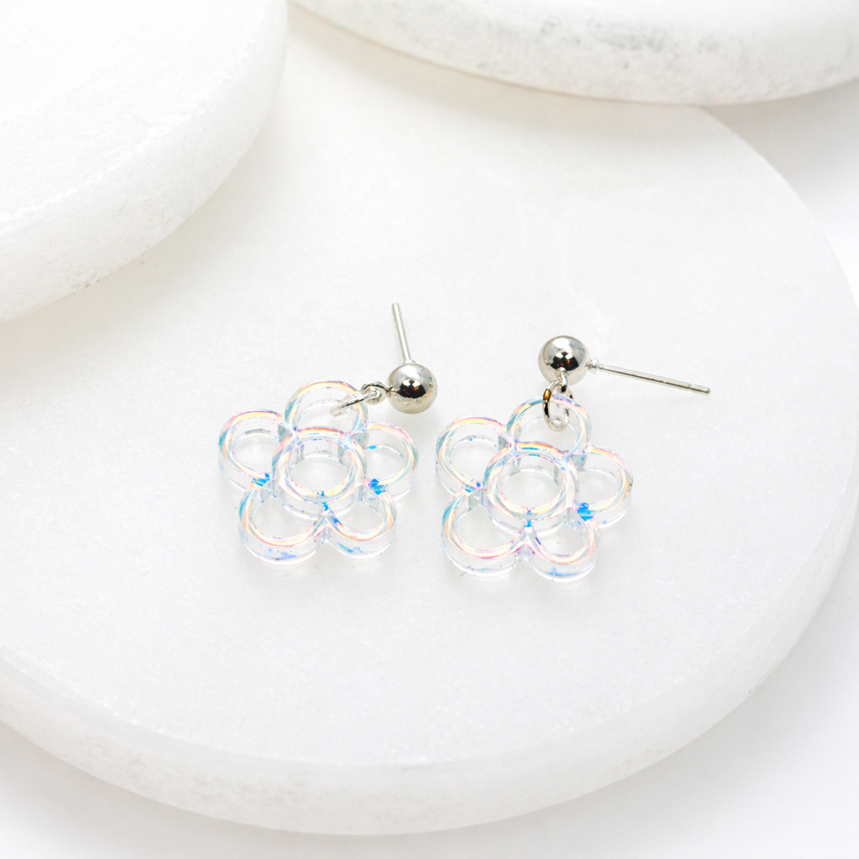 Iridescent flower dangle earrings with a lightweight, airy design that catches the light beautifully—soft, playful, and perfect for adding a subtle shimmer to any look.