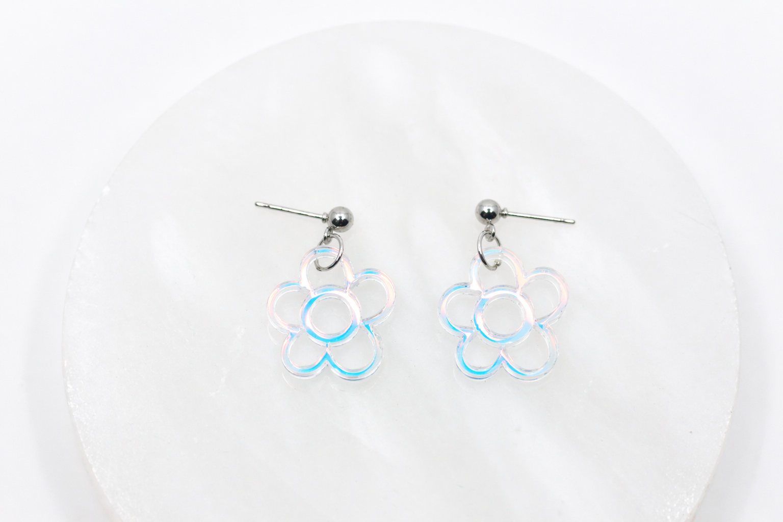 Delicate iridescent flower stud earrings featuring a soft, light-catching shimmer—dainty, feminine, and perfect for adding a subtle glow to any outfit.