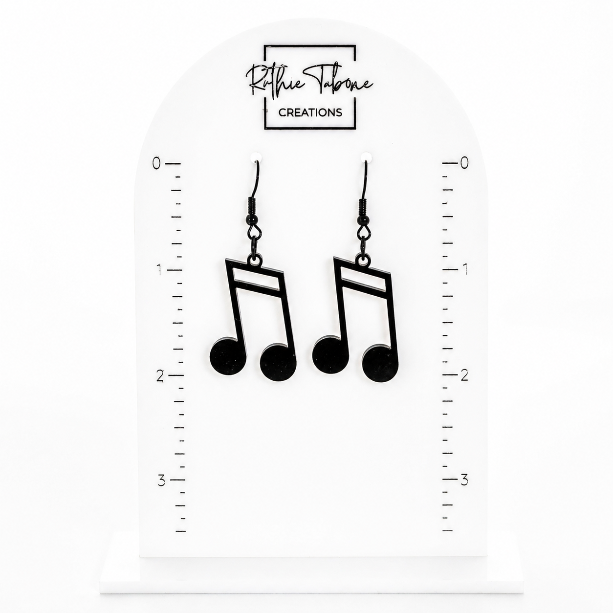 Black music note dangle earrings with hook backs shown on measurement display card