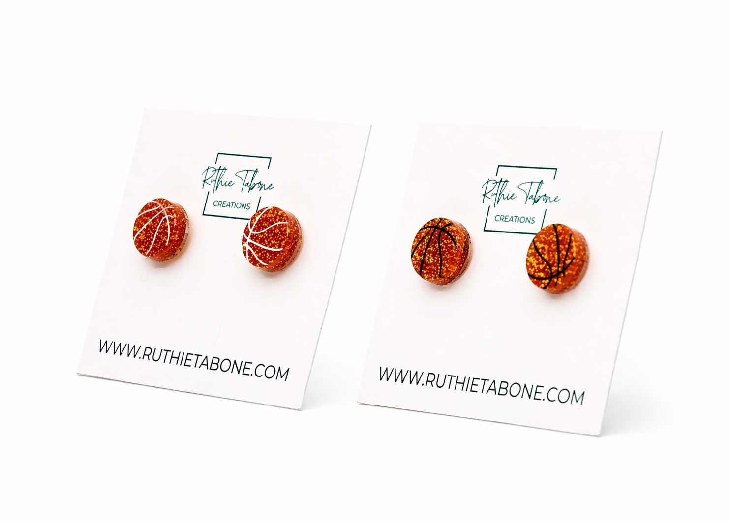 Two styles of glitter basketball stud earrings—white line and black line designs—displayed on Ruthie Tabone Creations cards in an angled side-by-side product view.