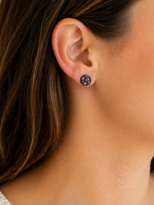 Black soccer ball stud earrings worn on a model, featuring a classic pentagon pattern in a sleek, minimalist design—perfect for soccer players, fans, and everyday sporty style.