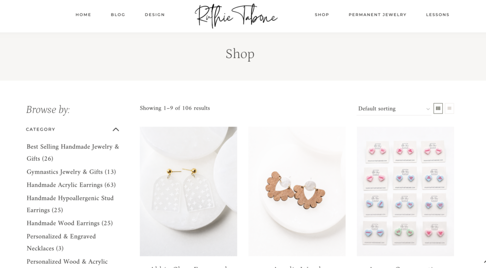 Shop page on the Ruthie Tabone website featuring handmade jewelry categories, including handmade acrylic earrings, wood earrings, hypoallergenic stud earrings, gymnastics jewelry and gifts, and personalized engraved jewelry. Product listings display handmade earrings with category filters and shopping options.